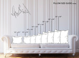 White sofa with nine white pillows arranged by size from smallest (12x12 inches) to largest (26x26 inches), with labeled pillow dimensions above each pillow.