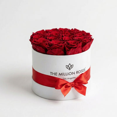 Classic White Box containing 14-15 naturally preserved red roses arranged in a white box by The Million Roses.