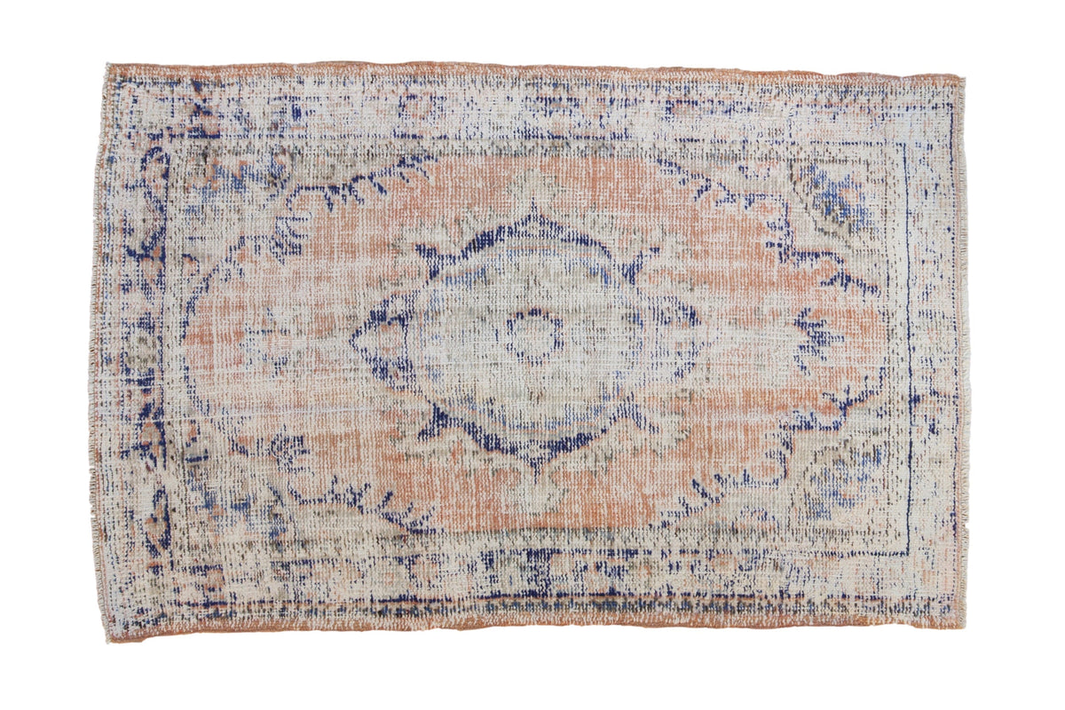 3x4.5 Vintage Distressed Oushak Rug featuring dusty apricot, ivory, and cobalt blue with a roundel center medallion and distressed wear