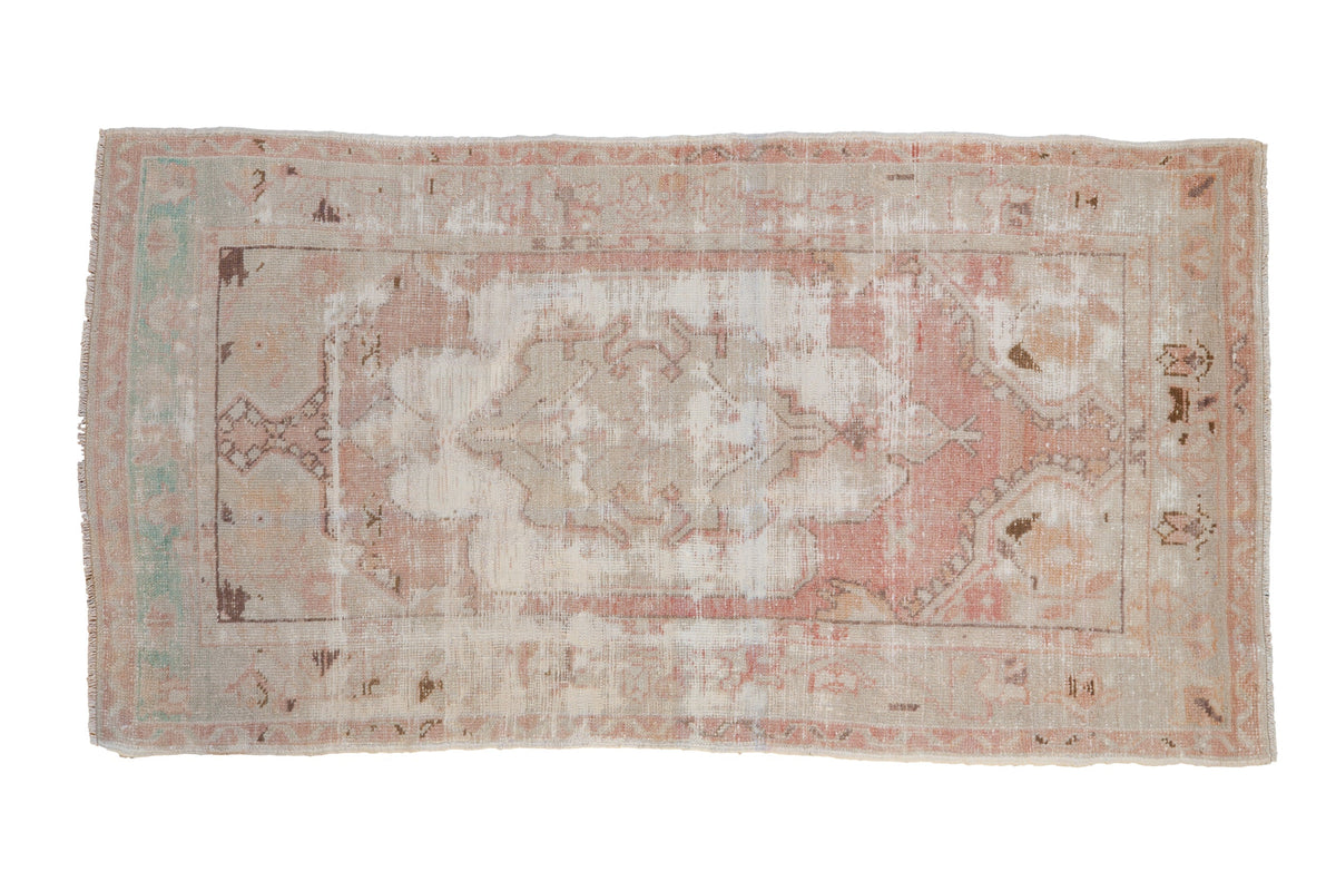 2.5x5 Vintage Distressed Oushak Rug Runner showing an ivory background with dusty rose and pale saffron floral medallion and distressed wear