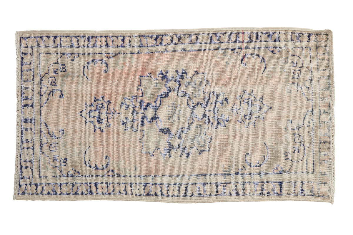2.5x4.5 Vintage Distressed Oushak Rug with muted floral quatrefoil patterns in dusty rose and cobalt blue hues