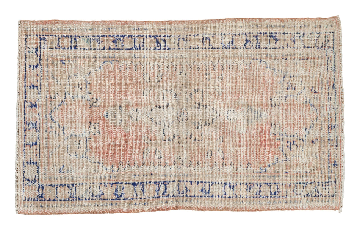 2.5x4.5 Vintage Distressed Oushak Rug showing starburst center medallion and worn areas