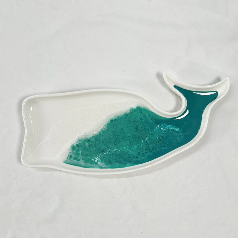 Whale-shaped resin ceramic plate with teal interior on a light gray background