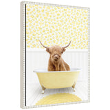 Framed floating canvas art showing a Highland cow in a yellow bathtub in a cottage scene.