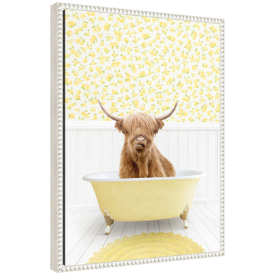 Framed floating canvas art showing a Highland cow in a yellow bathtub in a cottage scene.