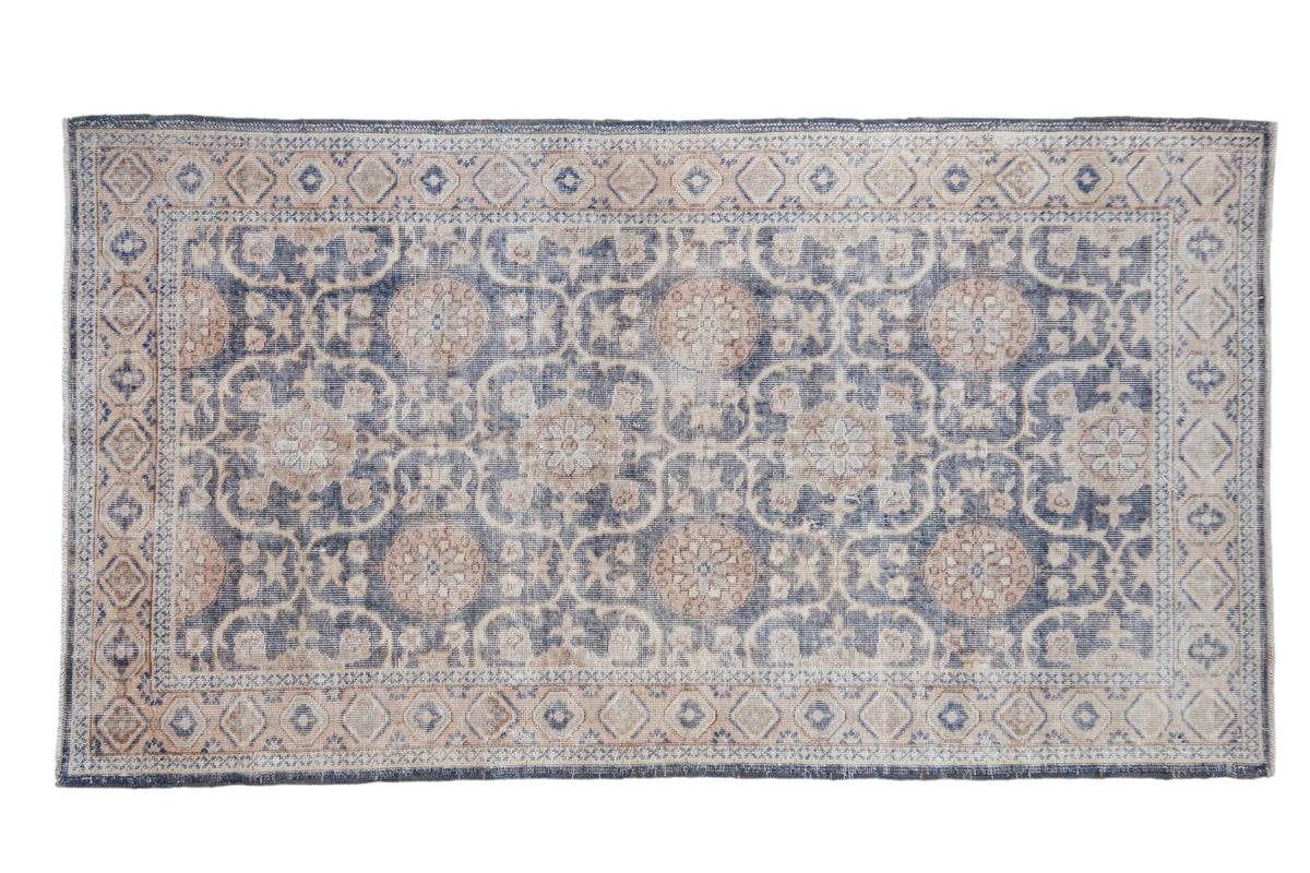 4x7 Vintage Distressed Sparta Rug displaying trellis and floral pomegranate design in tones of denim blue, cream, ivory, and dusty sandalwood
