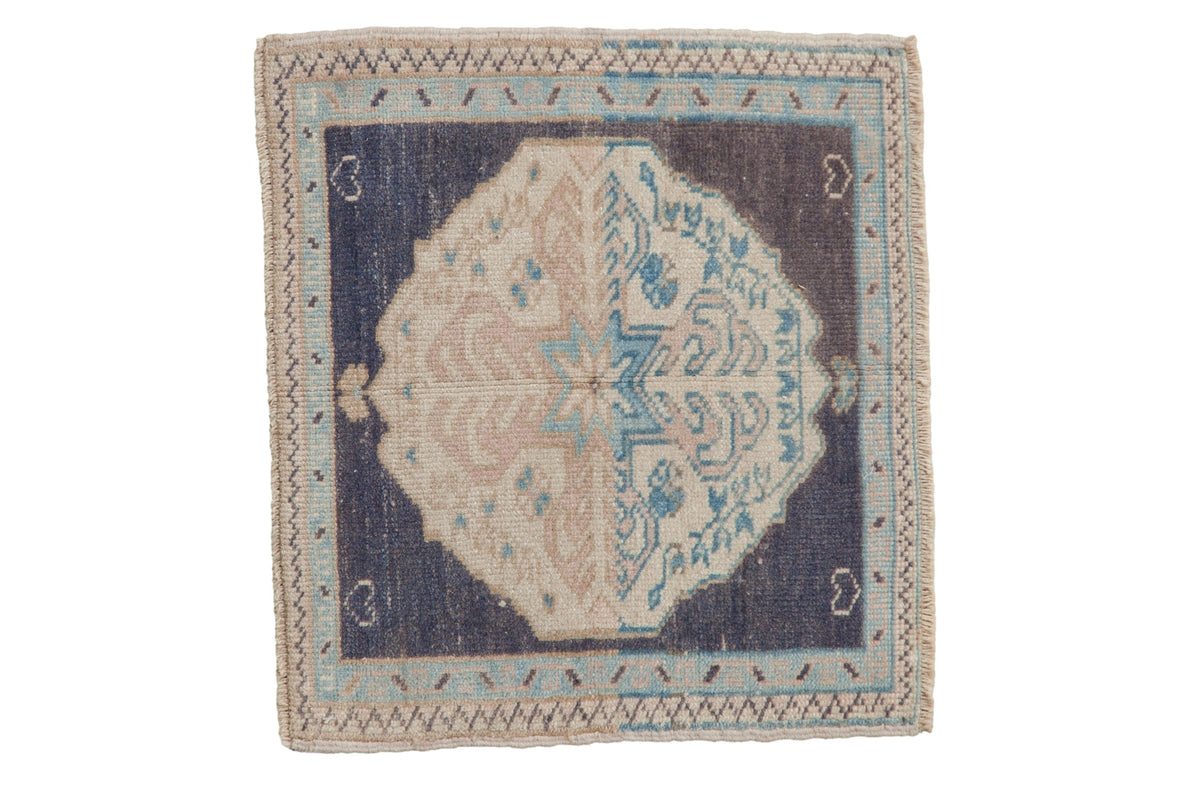 Vintage distressed Oushak square rug mat featuring quatrefoil medallion and pomegranate starburst motifs in muted dusty navy, blush, and bronze tones.