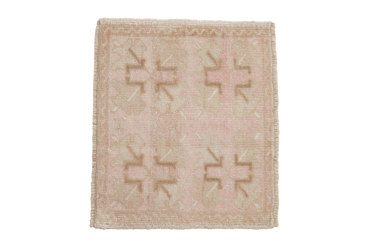 Vintage distressed Oushak square rug mat in cream, beige, sand, and dusty rose colors with geometric floral and zig zag border
