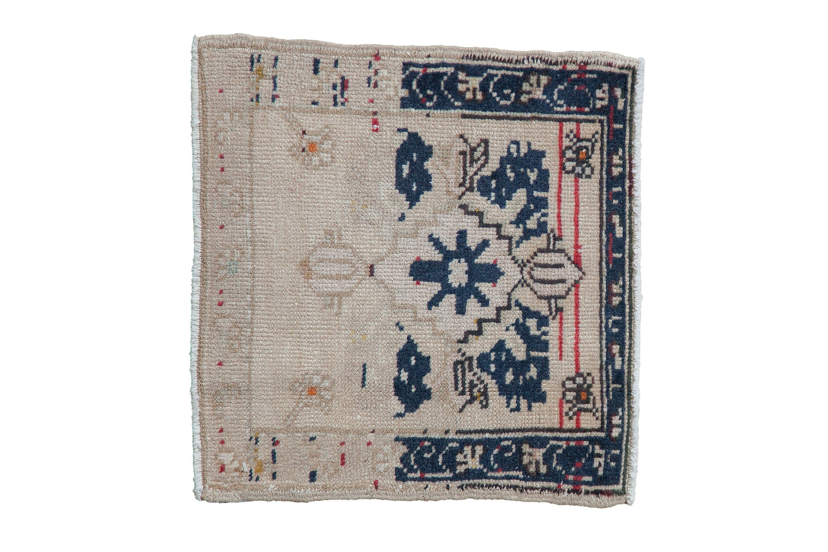 Vintage distressed Oushak square rug mat featuring stepped medallion and floral motifs in ivory, navy blue, beige, and cherry red