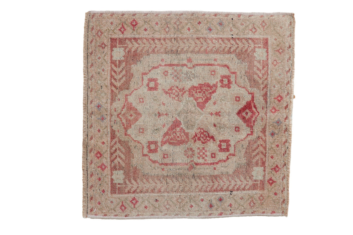 Vintage distressed Oushak square rug mat in antique ivory, dusty blush, and faded raspberry red, showing floral and quatrefoil medallion motifs.