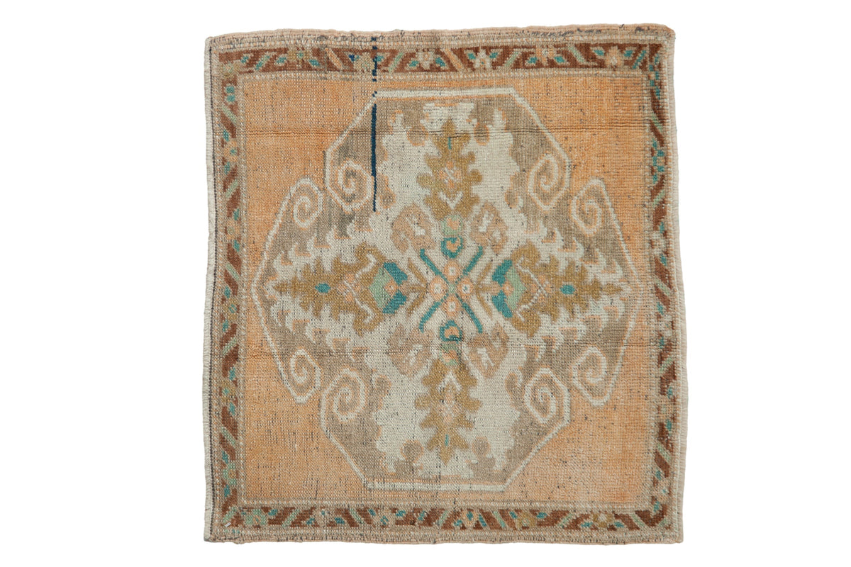 Vintage distressed Oushak square rug mat with large medallion and multicolored design in a worn patina