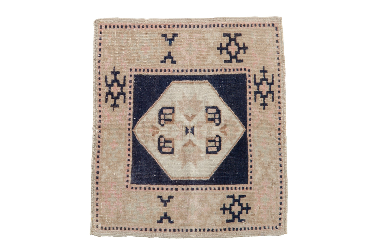 1.5x2 Vintage Distressed Oushak Square Rug Mat showing quatrefoil medallion with serrated leaf, geometric border, and muted color palette, laid on floor.