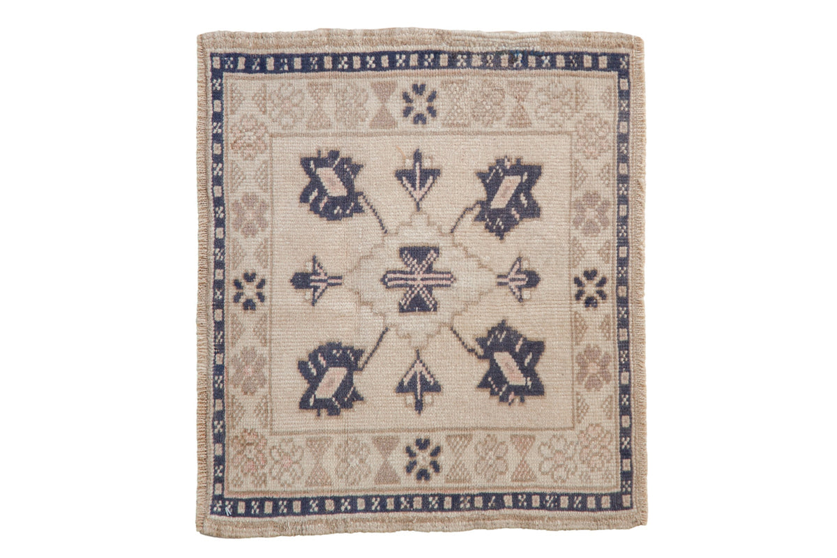 1.5x2 Vintage Distressed Oushak Square Rug Mat showing diamond shaped medallion and blossom motifs in ivory, beige, dusty navy blue and sand colors