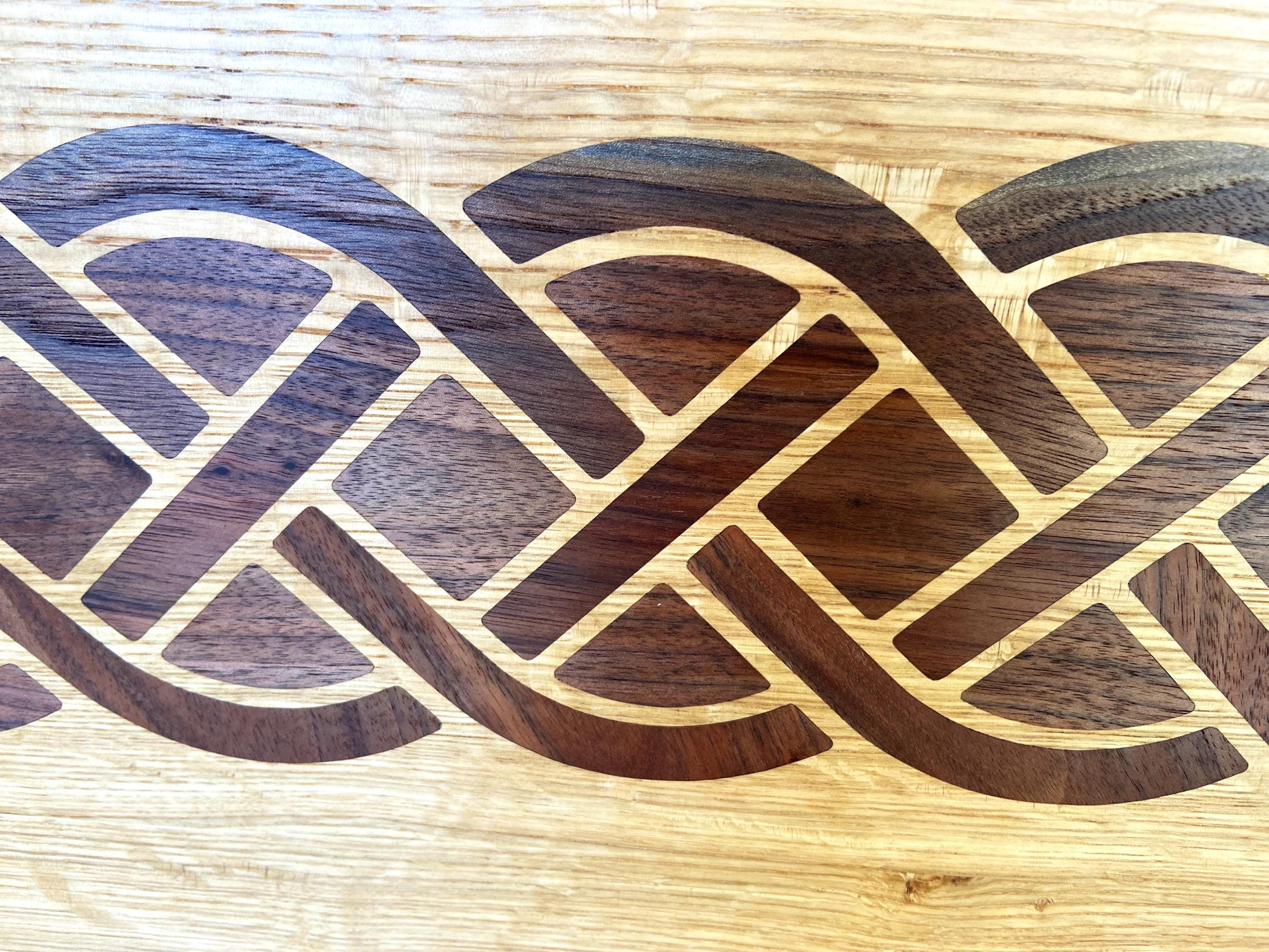 White Oak charcuterie board featuring a complex Celtic knot inlay made of Peruvian Walnut