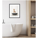 Framed wall art print of a cheetah sitting in a black and white bathtub on a black and white tiled floor, hung above a modern white freestanding bathtub with a towel draped over its edge.