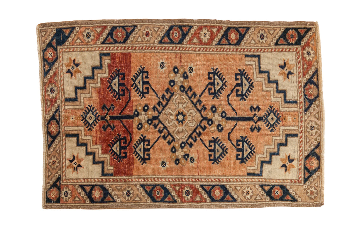 2.5x3.5 Vintage Distressed Dosemealti Rug with diamond medallion and floral starburst design in copper, navy blue, and neutral tones