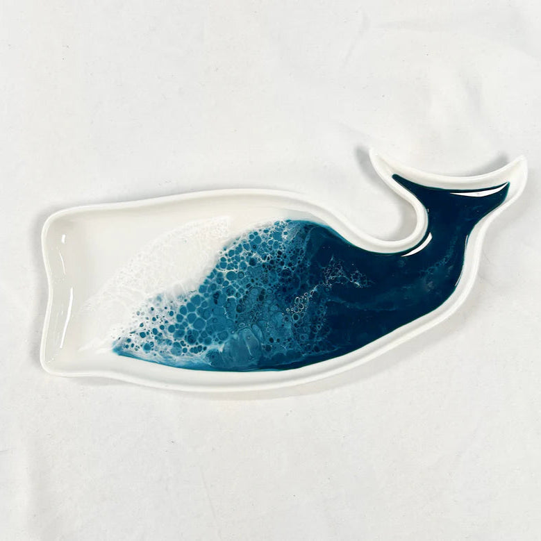 Ceramic resin whale-shaped plate with blue wave design on a white background