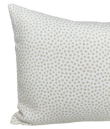 Rectangular white pillow with a subtle pattern of evenly spaced, small tan dots covering its surface.