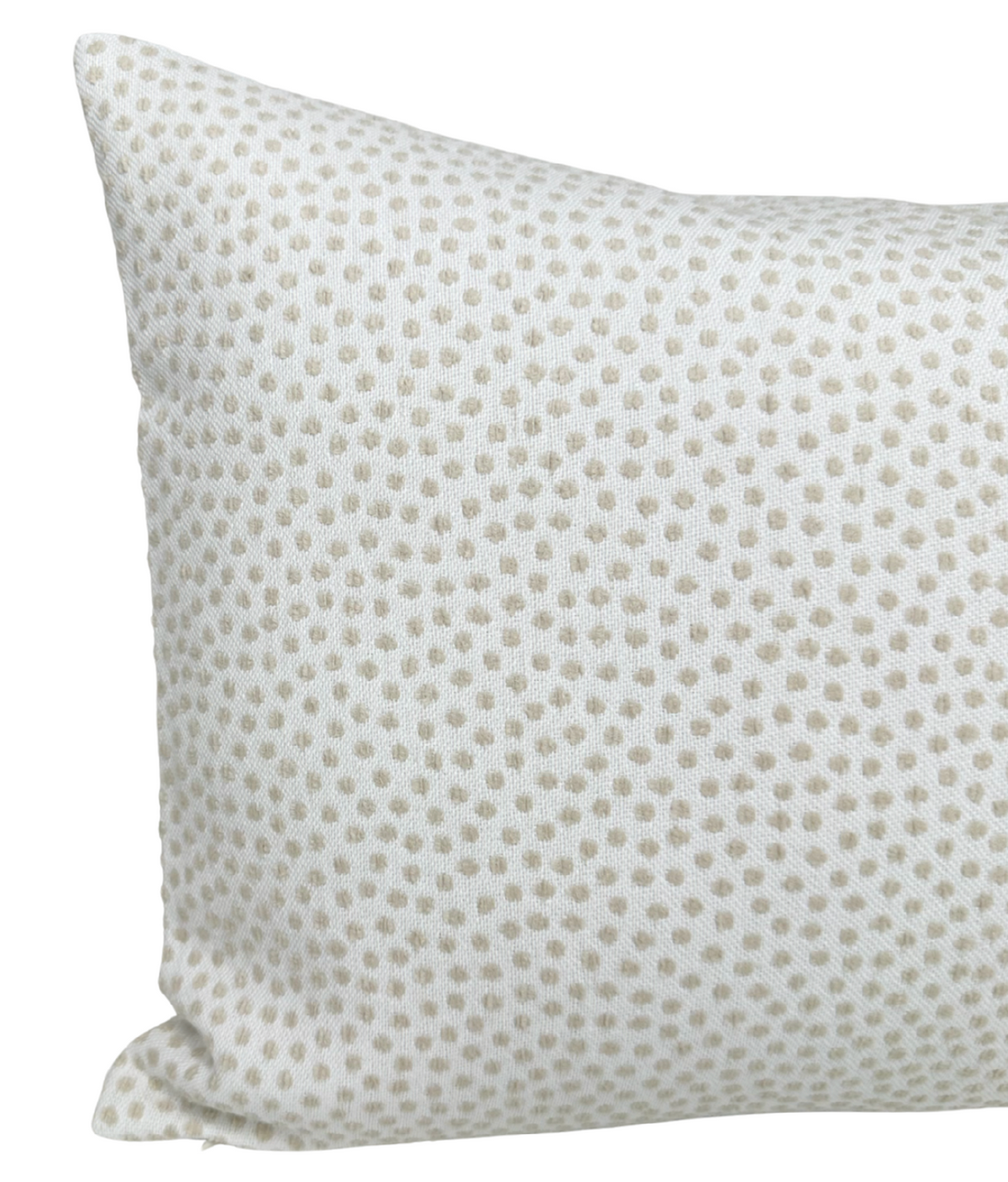 Rectangular white pillow with a subtle pattern of evenly spaced, small tan dots covering its surface.