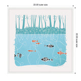 Linocut framed canvas showing stylized black and orange patterned fish swimming in a blue river beneath teal trees and flowers, titled Sylvie Coastal Blue River by Giuliana Lazzerini
