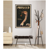Vintage-style framed canvas print of an ostrich smoking a pipe with text 'Prosecco' and 'Cold, Dry & Bottomless' on a dark background hanging above a modern bench and coat rack.