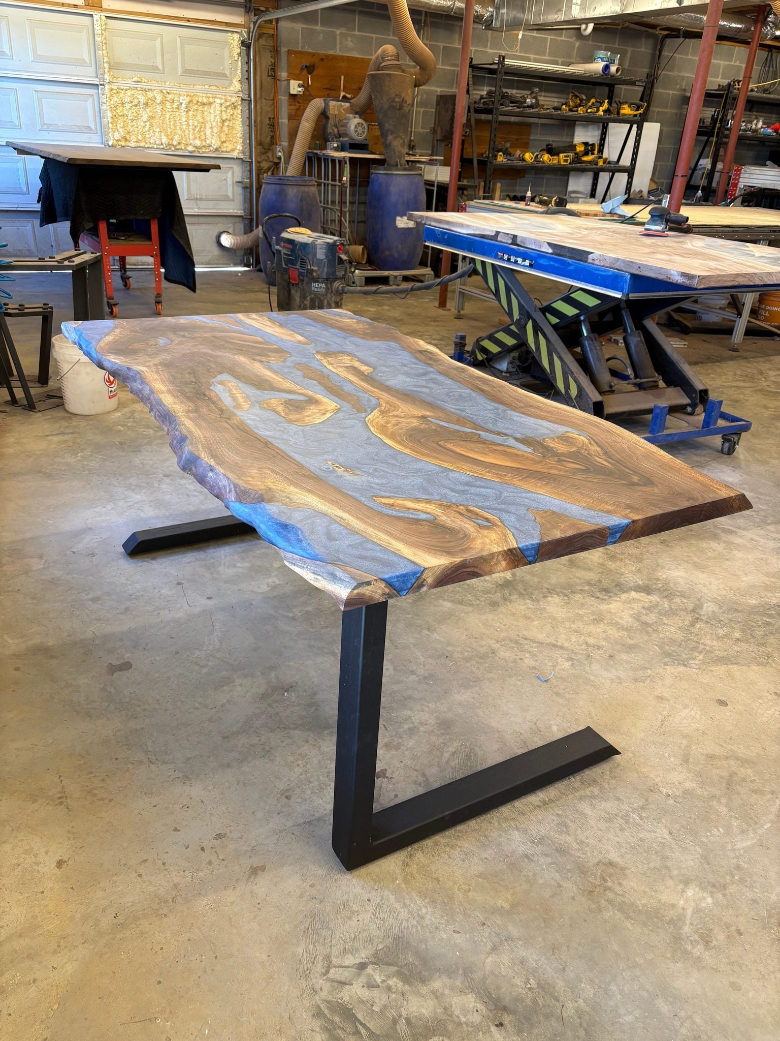 6x3 walnut river table with blue resin inlay in a workshop setting