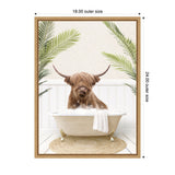 Brown Highland cow with long shaggy hair sitting in white clawfoot bathtub surrounded by green palm leaves against white wood panel background