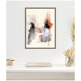 Abstract watercolor artwork with muted tones of black, beige, and reddish-orange accented by white brush strokes, framed and hanging above a minimalist white desk with dried flowers.