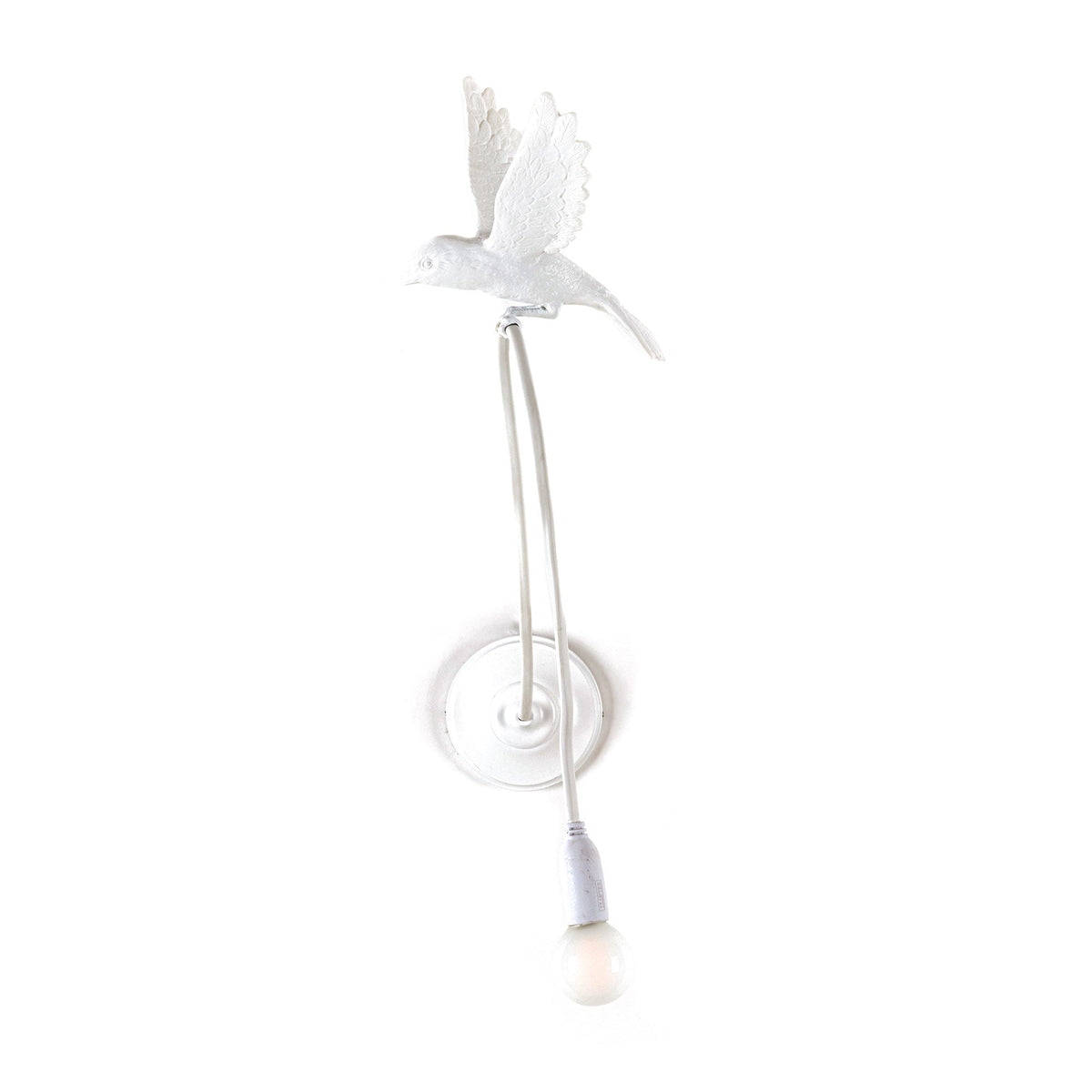 White wall lamp shaped like a flying sparrow with an exposed bulb hanging from a flexible cord below, mounted on a round base.