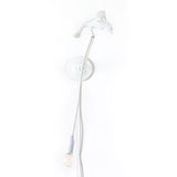 White wall lamp featuring a bird figure perched on the fixture with a long white cord ending in a bulb hanging down