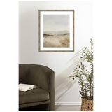 Abstract landscape painting with soft beige and gray tones in a rustic wooden frame, hung above an olive green armchair next to a potted olive tree.