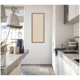 Tall narrow kitchen with concrete-look counters and white cabinets, featuring a framed beige print with green lattice pattern on the far wall.