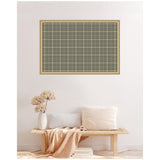 Rectangular pinboard with sage green plaid fabric and thin wooden frame, hanging above a minimalist bench with beige cushions and a dried flower vase.