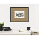 Black and white sketch of a Venice canal scene with a bridge and boat, matted in tan and framed in black, hanging above a white desk with books, cup, and plant.