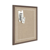 Rectangular pinboard with beige fabric surface and a dark brown wooden frame, featuring a white scalloped edge pattern and two black-and-white photos pinned near the top left.