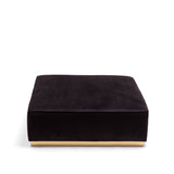 Square black upholstered pouf with smooth fabric surface and light beige flat base, shown from the front on a white background.