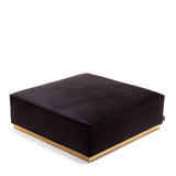 Square black fabric pouf with gold base, shown at a slight angle on a white background.