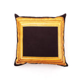 Square pillow with a black center bordered by a detailed, ornate gold frame printed on fabric, creating the illusion of an empty picture frame.
