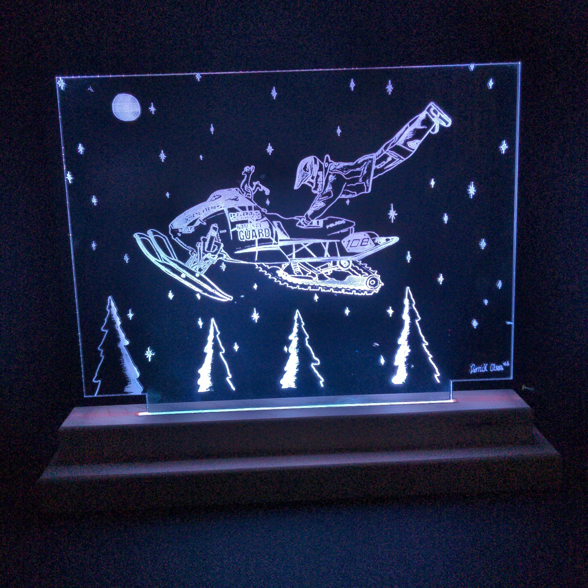 Leaping Levi Levalle laser cut clear acrylic design on a handmade LED light stand glowing with soft LED light