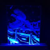 Blue LED-lit etched glass panel depicting a flying pheasant soaring over a barbed wire fence with a starry night sky in the background.