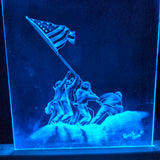 Blue LED-lit etched acrylic panel depicting soldiers raising an American flag on a mound, inspired by the iconic Iwo Jima image, signed by Derrick Olson 2017.