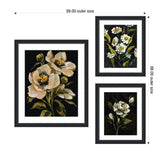 Three framed floral prints with dark backgrounds, featuring white and cream flowers with green leaves, arranged in a balanced 39 by 38 inch composition.