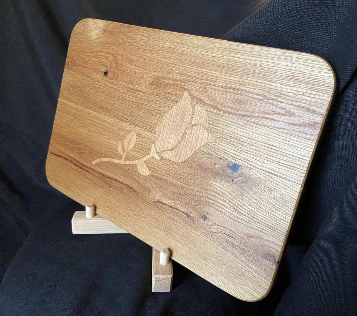 White Oak charcuterie board with subtle Cherry rose and stem inlay, handcrafted by Fitzgerald Custom Woodcraft