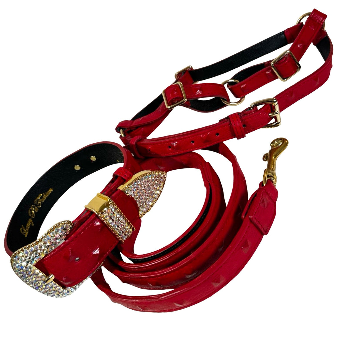 Red leather dog collar and leash set with gold-tone buckles, featuring a crystal-encrusted buckle on the collar and matching red harness parts.