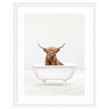 Highland cow with long hair and curved horns sitting inside a white clawfoot bathtub on a white tiled floor against a plain light wall.