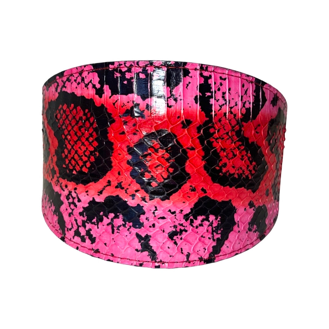 Fuchsia, light pink, red, and black wide snake-style collar with gold hardware displayed on white background