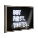 Framed printed glass wall art with neon-style typography reading 'But First Coffee' on a dark background