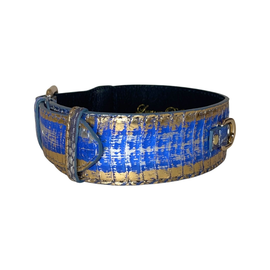 Leather dog collar with classic gold hardware featuring a multi-color snake pattern in blue, silver, and gold on the outer surface and black inner lining.