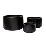 Set of three matte black cylindrical planters of varying sizes with smooth surfaces and no visible texture, shown side by side on a white background.