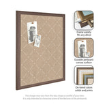 Beige canvas pinboard with white lattice pattern in a medium brown wooden frame, displaying two black-and-white photos pinned with wooden pushpins.